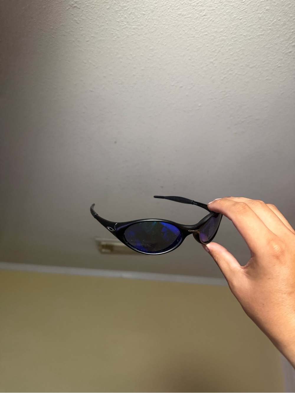 Oakley Black Frame Sunglasses with Blue Mirrored Lenses